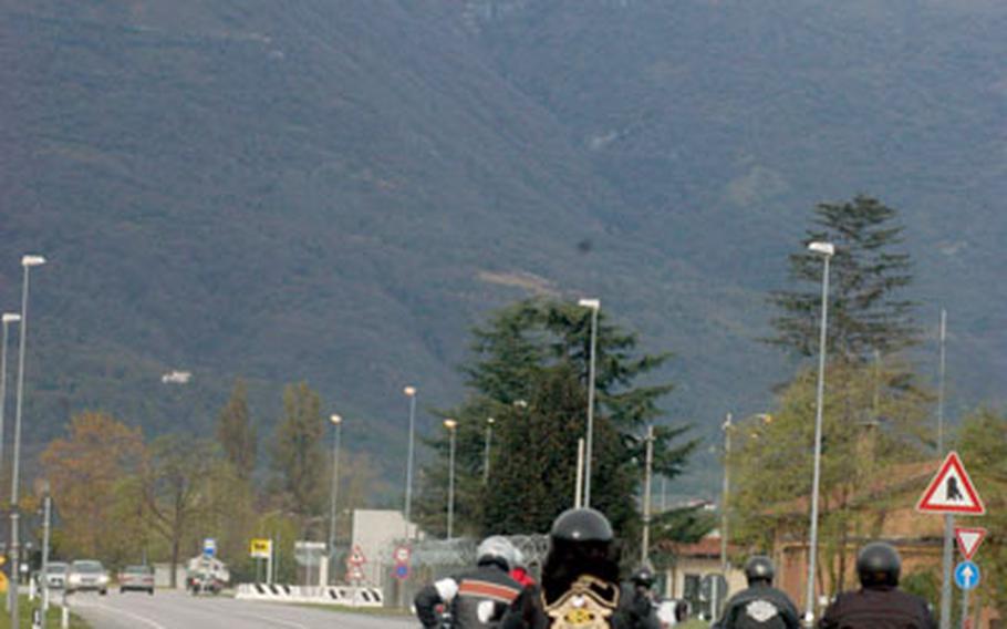 Members of the Aviano chapter of Harley-Davidson owners drive near snow-capped mountains Thursday on the way to pay tribute to a former servicemember on Veterans Day. The group visited the gravesite of Senior Master Sgt. Mogens George Jorgensen, who died in Germany in 1987 and is interred in Revine Lago, Italy.