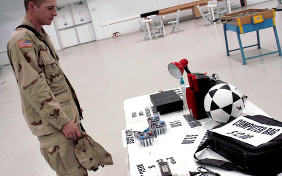 Pfc. Jeremy Scott, with the 1st Battalion 24th Infantry Regiment, looks over FOB Marez&#39;s "Yard Sale".