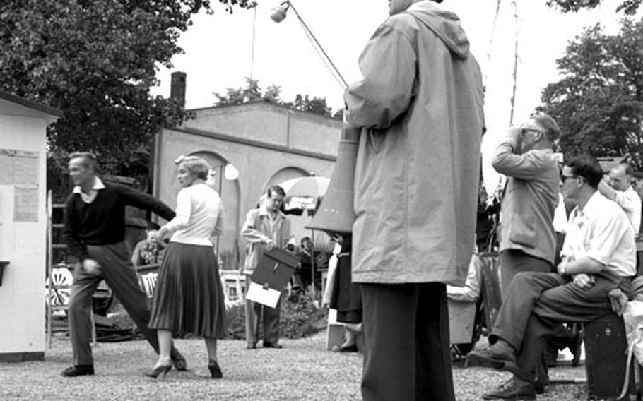 Director Mark Robson watches as Richard Widmark and Mai Zetterling act out a scene from ''A Prize of Gold.''