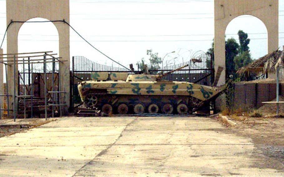 An old Iraqi tank blocks the entrance to FOB Wilson. Under Saddam Hussein, the base was a manufacturing plant for radio, radar and other electronics systems.