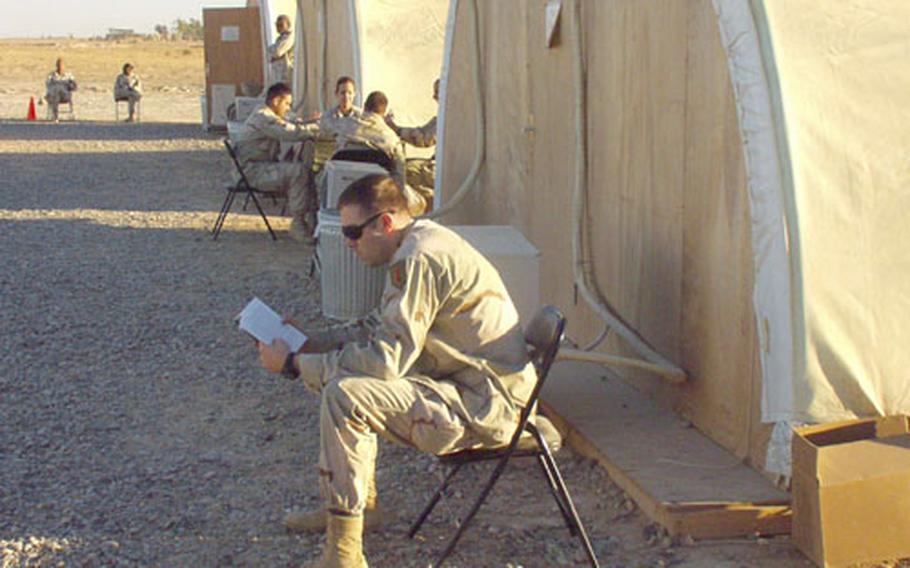 Capt. Tom Klump, 25, of the 1st Battalion, 7th Field Artillery, reads as he waits for a C-130 outside the passenger terminal tents at the airfield at Camp Speicher, Iraq. Klump, the battalion&#39;s personnel officer, said the new passenger service at Speicher means his soldiers heading home for R&R don&#39;t have to travel in long, dangerous convoys to catch their flights nearly as often.