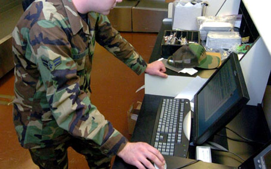 Airman 1st Class Brian Bicham of the 730th Aviation Maintenance Squadron checks the ticketing computer for bugs Tuesday at the newly renovated passenger terminal on Yokota Air Base, Japan.