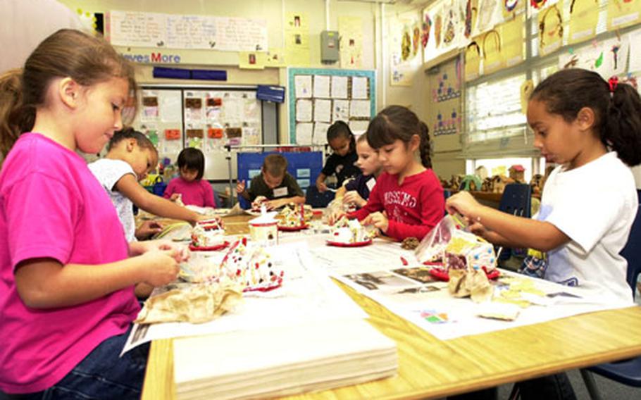 Students in Diane Jackson&#39;s first-grade class at Camp Foster, Okinawa&#39;s Zukeran Elementary School put the finishing touches on their gingerbread house creations Tuesday.