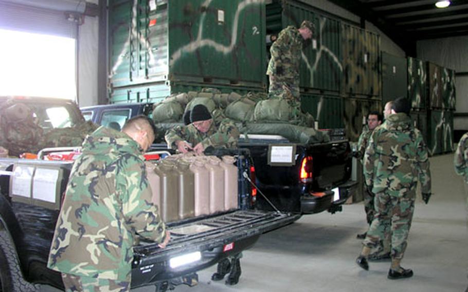 Airmen of the 554th Red Horse Squadron ready their vehicles Wednesday for deployment to South Asia.