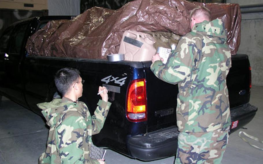 Airmen at Osan Air Base mark their vehicles Wednesday before deployment to South Asia.