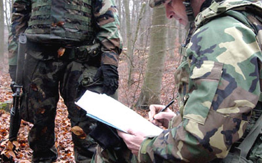 Tester Staff Sgt. Chris Allen, right, grades Spc. Tim Harris, after Harris completed the "move under direct fire" task at the 1st Armored Divsion&#39;s Soldier of the Quarter competition.