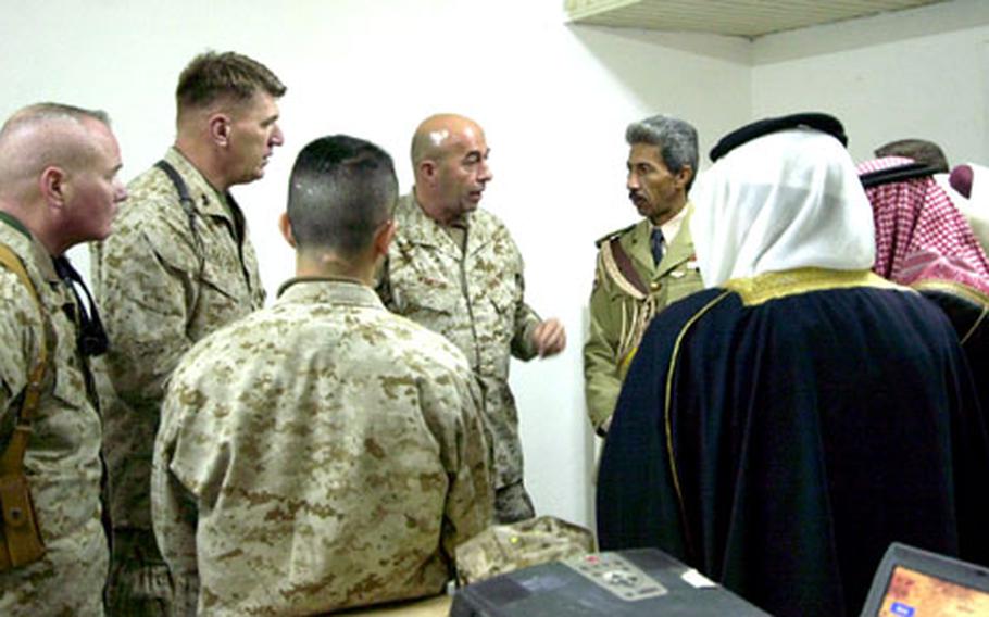 Col. Lee Miller, left, 31st Marine Expeditionary Unit commander, and 1st Marine Division commander Maj. Gen. Richard Natonski, second from left, meet Wednesday in Al Asad, Iraq, with a group of Anbar Province sheiks, imams and politicians. Marine officials were urging local Iraqi leaders to support upcoming elections.