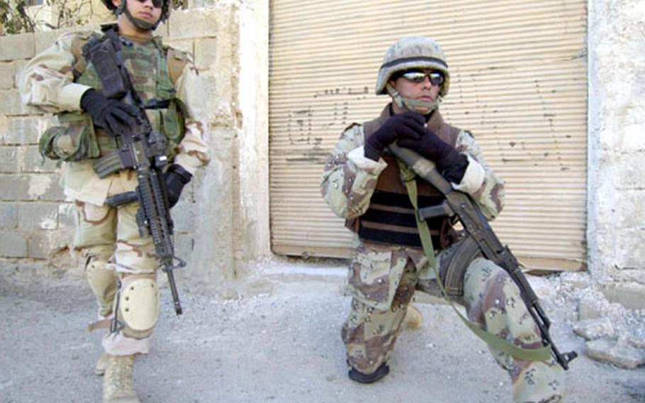 Sgt. Heriberto Vargas, of 1st Battalion, 9th Infantry Regiment, and an Iraqi National Guard soldier from India Company patrol the streets of a small town on the edge of Ramadi, Iraq.