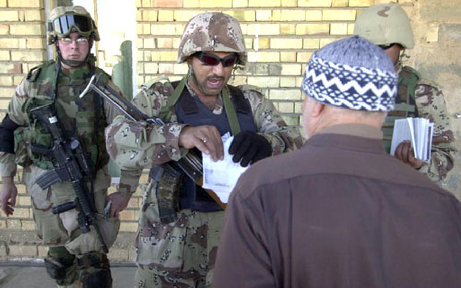 An Iraqi National Guard soldier tears up anti-American leaflets found at a mosque during a joint patrol of Iraqi and U.S. forces Thursday near Ramadi, Iraq.