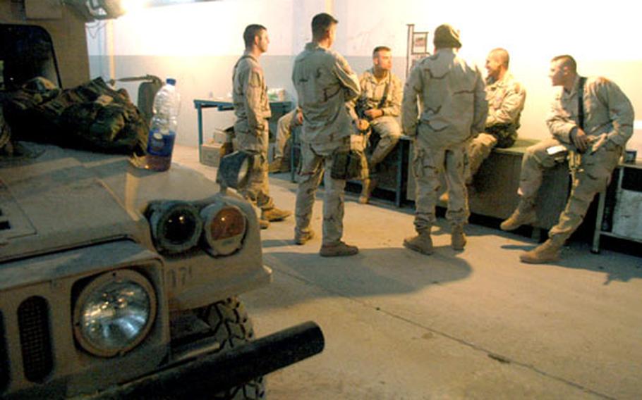 Soldiers from the Headquarters and Headquarters Company 2nd Battalion, 14th Infantry Regiment’s Mortar Platoon take a break after searching nearby fields for weapons caches.