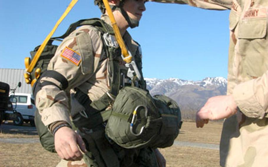 Staff Sgt. Shaun Pearsall checks Spc. Robert Lliteras&#39; parachute prior to a jump Wednesday at the Juliet drop zone.