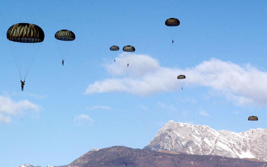 With the snow-topped Dolomite mountains in the background, paratroopers float through the air over the Juliet drop zone.