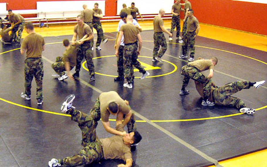 Soldiers of 1st Battalion, 27th Field Artillery practice jujitsu moves at the gym in Babenhausen, Germany on Wednesday.
