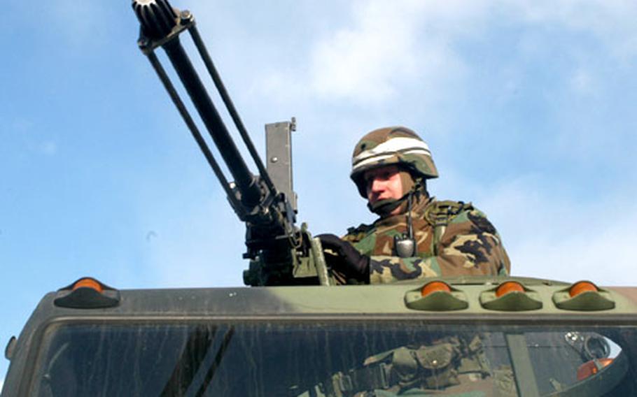 A soldier with 2nd ID&#39;s Aviation Brigade mans a .50-caliber machine gun atop a gun truck during convoy training at Rodriguez Range.