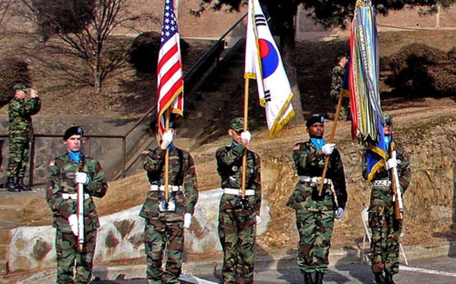 A color guard stands at attention during a ceremony Friday at Osan Air Base to commemorate a fierce Korean War engagement in February 1951 known as the battle of "Bayonet Hill."