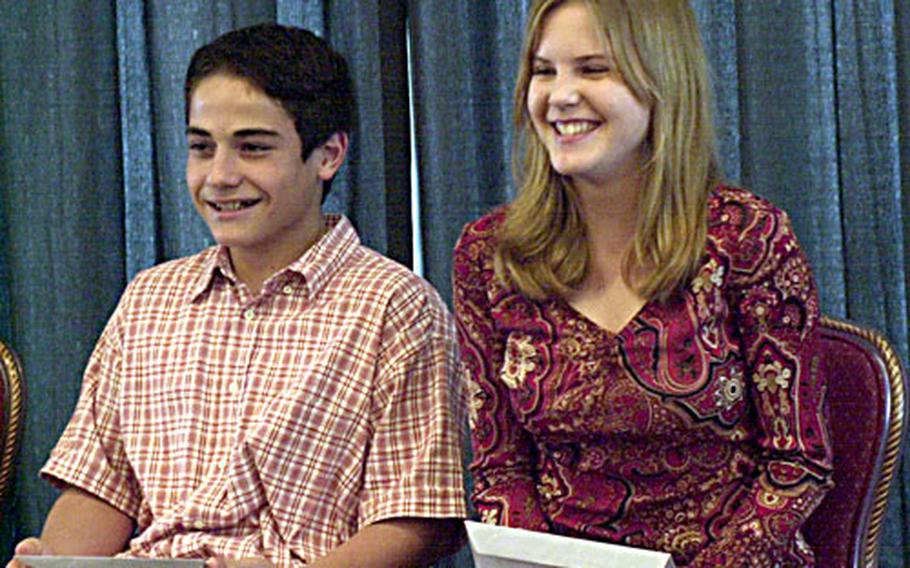 Harry Bloom, left, and Kendra Taylor smile after hearing their names announced Saturday as winners of the Ninth Annual Student Writing Contest at the Butler Officers Club on Okinawa.