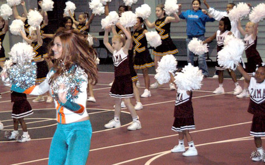 Miami Dolphin cheerleaders, visiting Camp Zama to help celebrate the Super Bowl, teach skills to cheerleaders from the Zama American High School and the Youth Center cheer squads during a cheerleading performance and clinic on Monday.