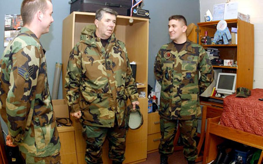 Air Force Gen. Paul V. Hester, center, talks with Senior Airman Stuart Cazares, left, and Senior Airman Andrew Adams in their dorm Tuesday at Kunsan Air Base in South Korea. Hester visited Kunsan as part of a weeklong set of visits to several air bases, three of them in South Korea.