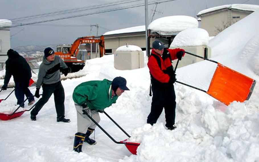 Sailors from the Yokosuka, Japan-based USS John S. McCain help dig out a school for the mentally challenged Tuesday in the city of Otaru on Japan&#39;s northern island of Hokkaido. The McCain completed a scheduled port visit to the city this week.