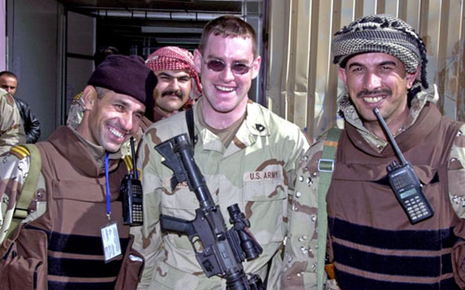 Jackson poses with some of the Iraqi troops he&#39;s been training for almost a year.