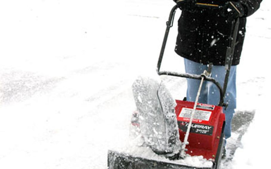 Rolly Flores revs up his snowblower in front of his main base house at Misawa Air Base on Tuesday.