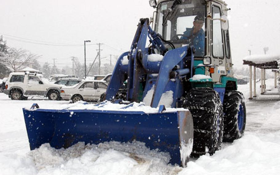 Snow is cleared from the Edgren High School parking lot Tuesday morning at Misawa Air Base.