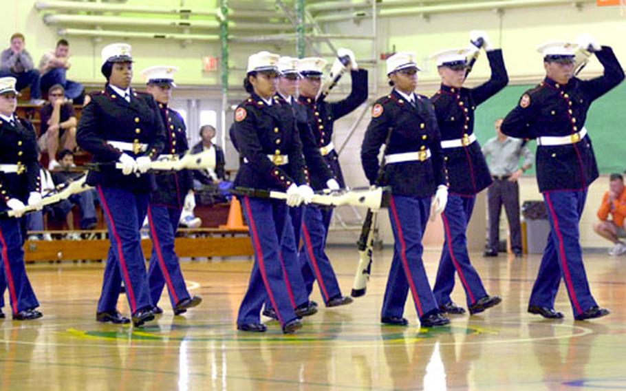 Members of Kubasaki High School&#39;s Marine Corps Junior Reserve Officers Training Corps drill team perform an eight-minute silent drill routine for their schoolmates Monday.