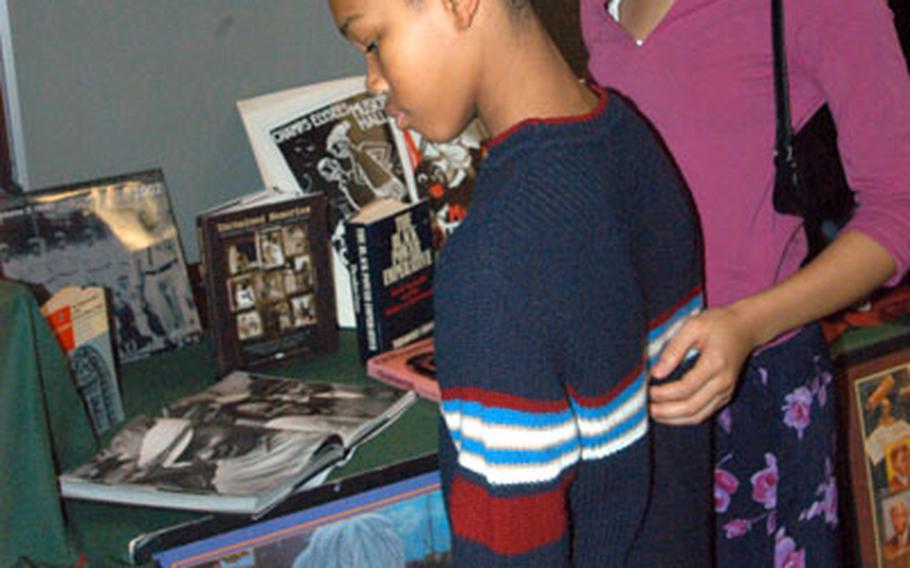 Elliot Knowles, 13, and his sister, Kimberly, 17, check out one of the exhibits at Wednesday&#39;s 6th Area Support Group Black History Month Luncheon at Patch Barracks. They are the children of Air Force Col. and and Mrs. Edward Knowles of the U.S. European Command&#39;s Nuclear Command and Control, Missile Defense Division.