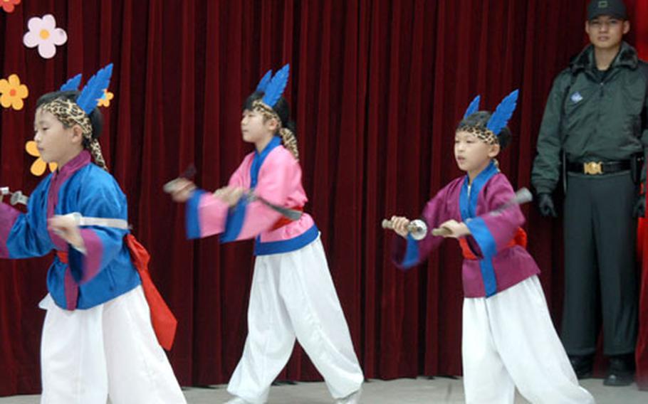 Students at the Tae Sung Dong Elementary School in the DMZ perform a dance Wednesday as part of the sixth-grade graduation ceremony.