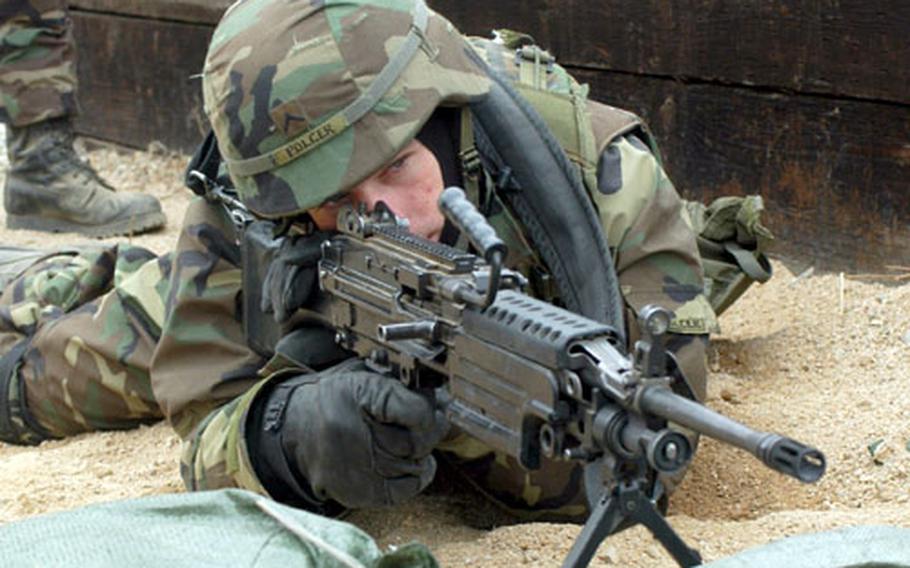 A soldier fires at targets in response to a simulated attack Tuesday at Storey Range.