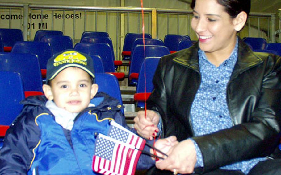 Sharmilla Gonzalez and her son, Christian, wait in a reception tent on a snowy night at Würzburg&#39;s Leighton Barracks for a reunion with their husband and father, Spc. Camilo Gonzalez, a soldier in the 1st Infantry Division&#39;s headquarters company.