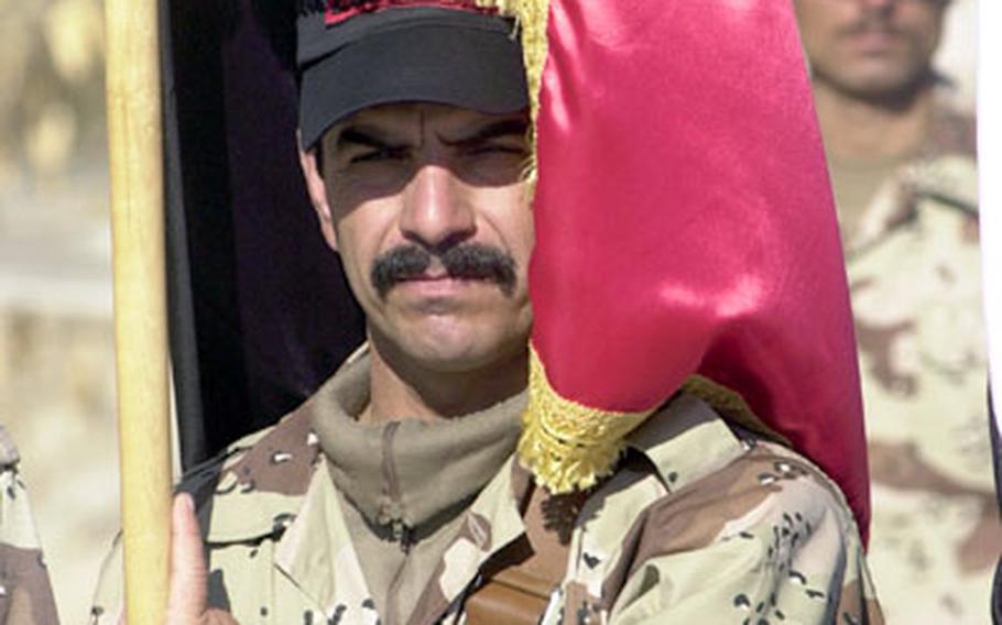 An Iraqi recruit wrapped himself in the new colors of the 4th Iraqi Division last month during a graduation ceremony.