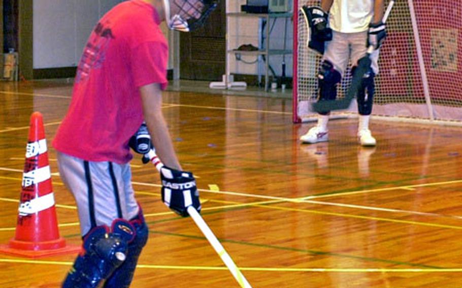 Floor hockey teammates prepare at Okinawa Koto-yogo high school Thursday for the upcoming World Games in Nagano, Japan.