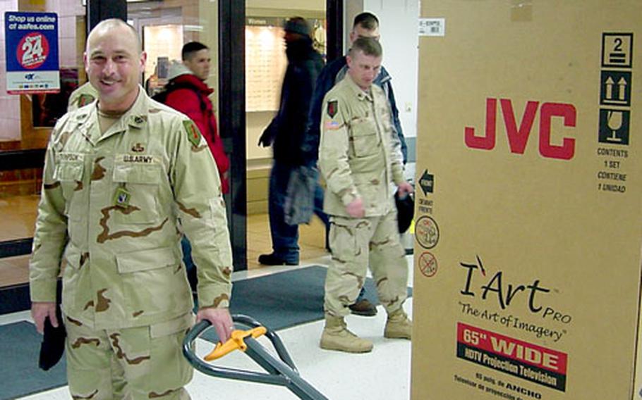 A soldier walks away with the 65-inch wide-screen TV he purchased at the Schweinfurt Power Zone on Friday. Army and Air Force Exchange Service-Europe has stocked up on popular items to gear up for the 1st Infantry Division’s return from Iraq.