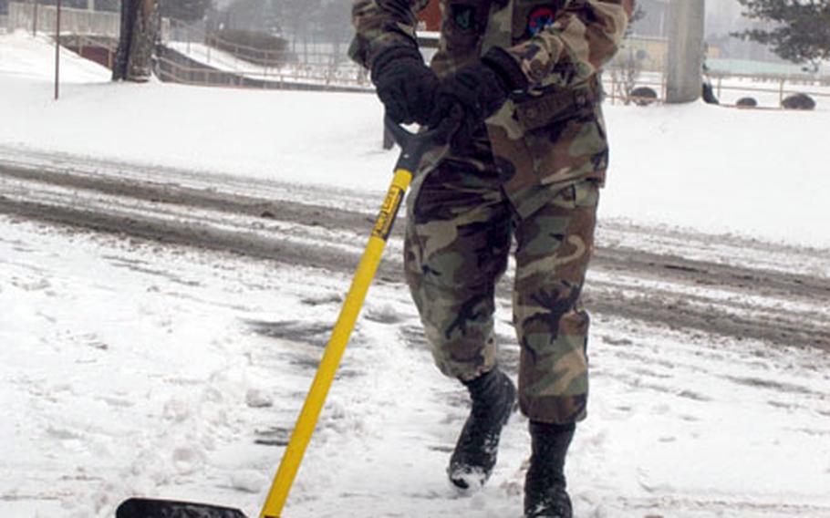 Detachment 1, 607th Weather Squadron Senior Airman Adam D’Anthony, 25, of Westminster, Md., shovels snow at Camp Red Cloud on Tuesday.