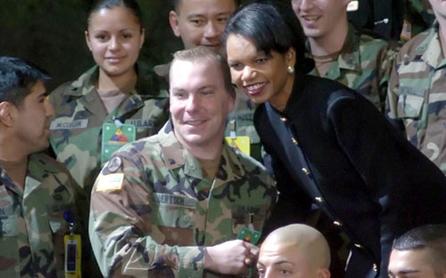 Secretary of State Condoleezza Rice poses for a photo with troops. Bush and Rice stopped in Wiesbaden as part of their European trip, during which the president is hoping to solidify ties with Western leaders, some of which were weakened by the U.S. invasion of Iraq.