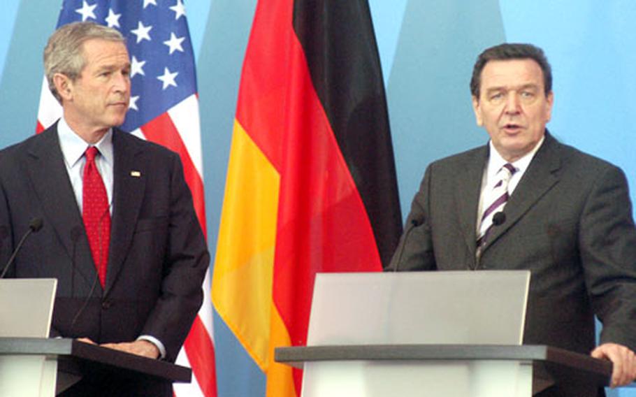 President Bush listens to German Chancellor Gerhard Schroeder during a meeting with the media in Mainz, Germany, following talks between the two leaders.