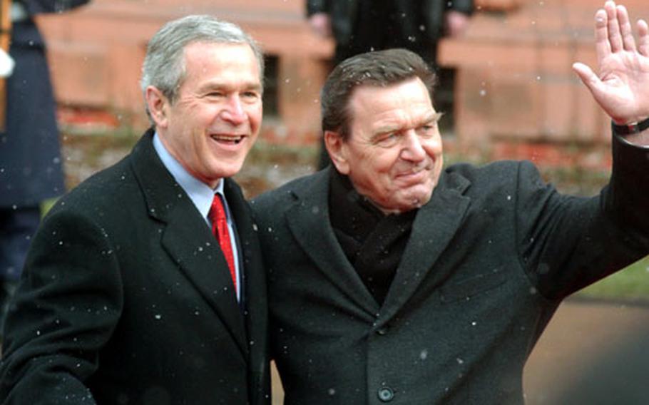 President Bush and German Chancellor Gerhard Schröder greet spectators and press during a military review at the Mainz Schloss on Wednesday.