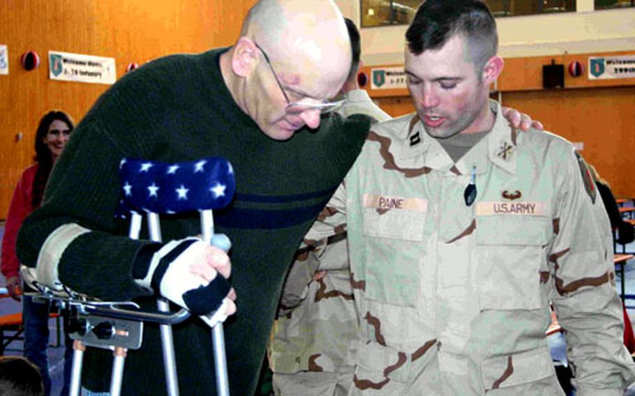 First Sgt. Brent Jurgersen, twice badly injured in Iraq, is reunited with Capt. Jeff Paine, commander of Headquarters and Headquarters Company, during a Friday homecoming celebration for the 1st Infantry Division’s 1st Squadron, 4th Cavalry Regiment, at Conn Barracks in Schweinfurt, Germany. The unit is currently returning from a yearlong tour of Iraq.