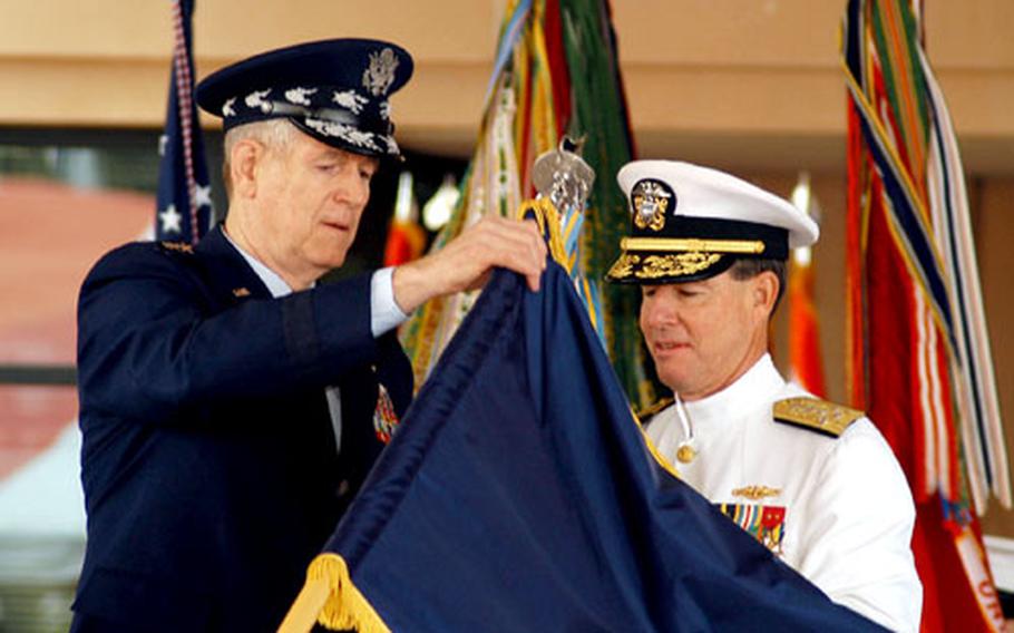 Gen. Richard B. Myers, chairman, Joint Chiefs of Staff, presents Adm. Thomas B. Fargo the Joint Meritorious Unit Award at the Pacific Command change-of-command ceremony at Camp Smith, Hawaii. Fargo was relieved by Adm. William J. Fallon.