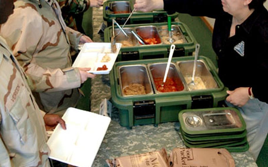 Kathy-Lynn Evangelos gives soldiers at the 44th Signal Battalion dining facility in Mannheim, Germany, a sample of new food rations being tested and implemented.