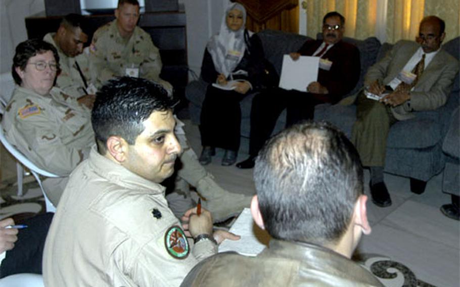 Lt. Col. Amir Adolphe A. Edward, foreground left, a senior Air Force medical adviser, interpets a discussion of health needs between local Iraqi leaders and representatives of nongovernmental organizations at a conference Sunday in Tikrit, Iraq. Behind Edward are, from left, Army Col. Joan Sullivan, division surgeon for the 42nd Infantry Division; and Sgt. Cruz Delacruz and Sgt. 1st Class Patrick Mason of the 411th Civil Affairs Battalion, U.S. Army Reserve.