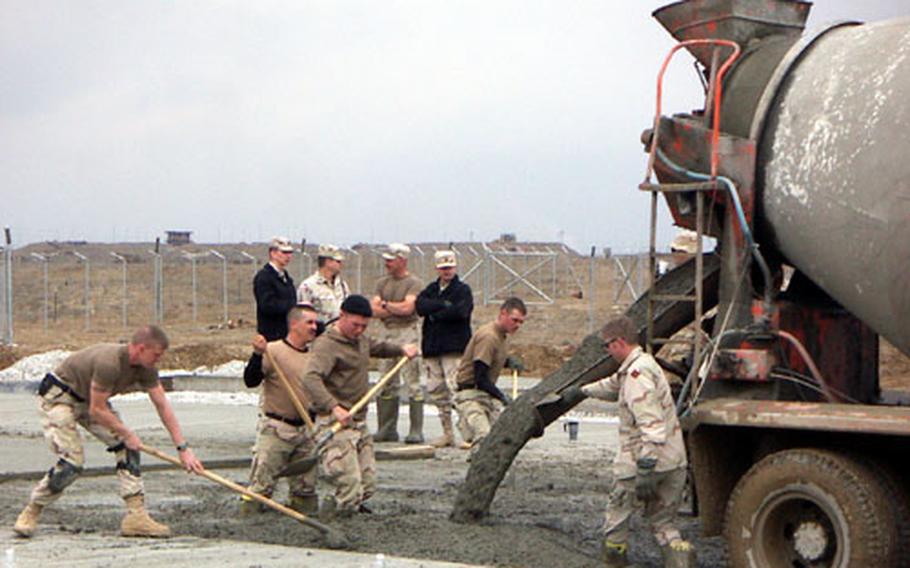 Soldiers prepare concrete pads at Bagram Air Base, Afghanistan, that will hold shelters where maintenance will be done.
