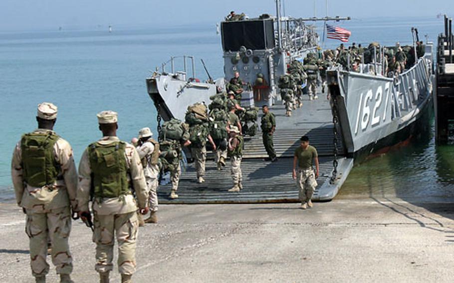 Marines and sailors of the 31st Marine Expeditionary Unit board a Landing Craft Utility for transport to the Essex Amphibious Ready Group on Monday.