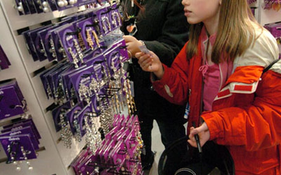 Nichole Mullis, left, from Girl Scout Troop 60 from Osan, Korea and Alexandria Caldwell-Rutter from Girl Scout Troop 33 from Misawa shop for earrings in Harajuku on a “Girls Night Out” Feb. 18.