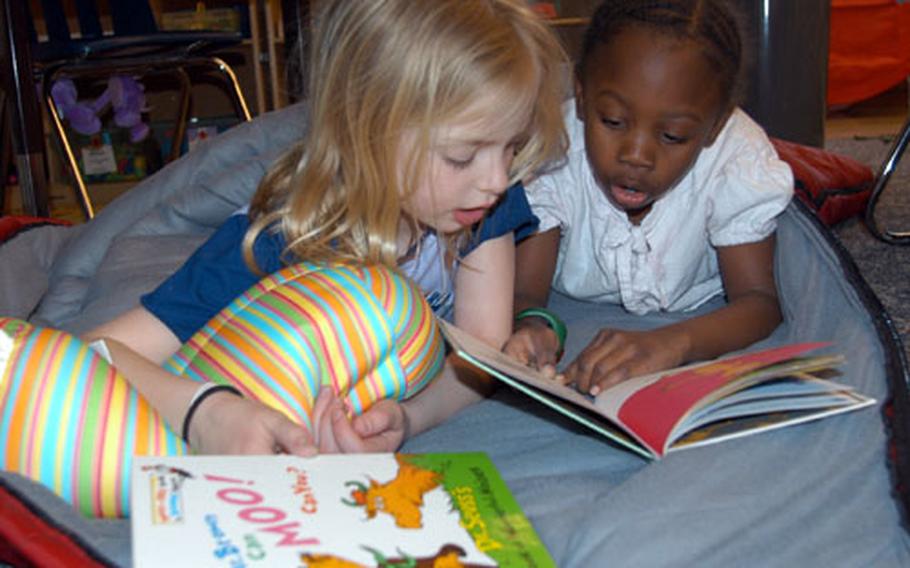 Sollars Elementary School second-graders Alexis Beshears, left, and Faith Moss read Dr. Seuss&#39; "The Foot Book."