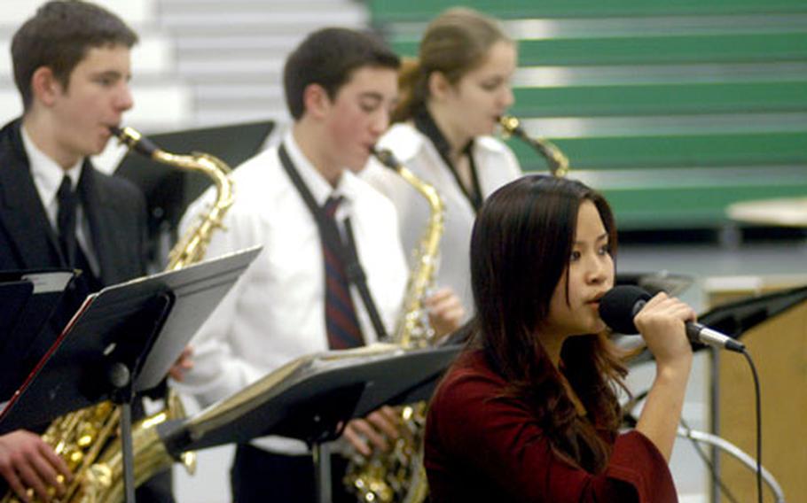 Kim Omune of the Naples High School jazz band sings at the end of the concert by the combined Aviano and Naples high school bands Wednesday night.