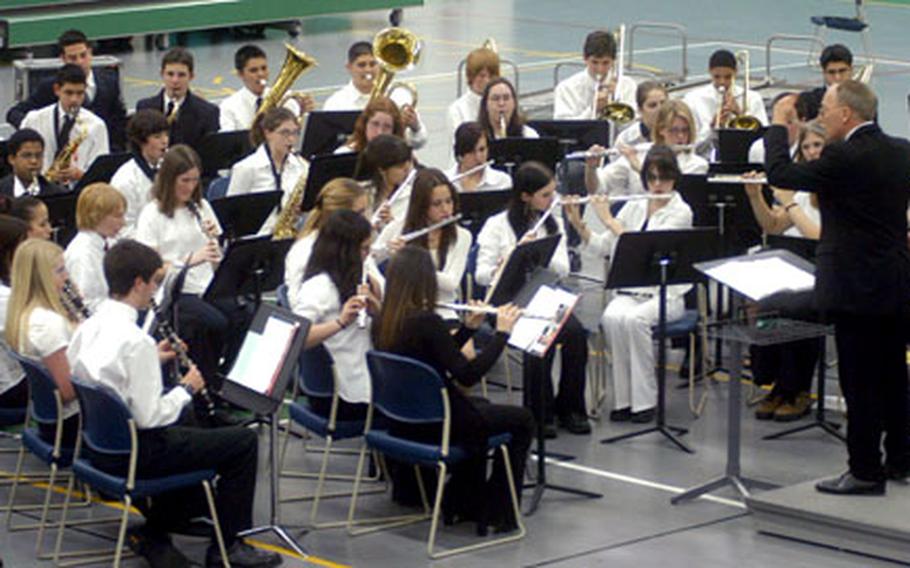 Gary Marvel, right, directs members of the combined Naples and Aviano high school bands during a concert Wednesday night at the Naples school gymnasium.