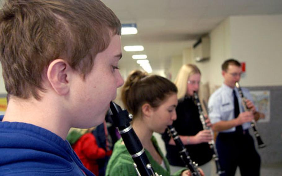 Ryan Fordham, an eighth-grader at Aviano High School, practices clarinet before a combined concert by Aviano and Naples high school band members. Clarinetists and oboists were helped during the day by Air Force Staff Sgt. Kenny Drefke, at right, a clarinetist with the NATO Joint Force Command band.