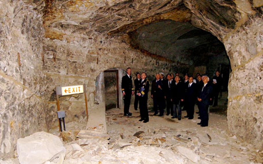 Guests take a tour of the caves under Yokosuka Naval Base, Japan, after a ceremony officially sealing the caves on Friday. The caves most recently were used for a command center for Commander, Naval Forces Japan.